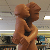 Terra Cotta sculpture depicting a mother holding her daughter