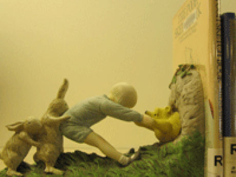 Winnie the Pooh bookends depicting Christopher Robin pulling Pooh from Rabbit's house