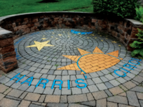 Harris' Circle of Friends is pavement art showing a sun moon and stars