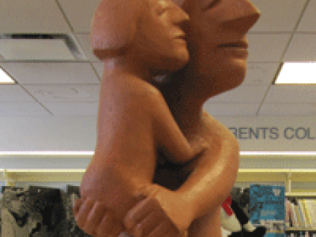 Terra Cotta sculpture depicting a mother holding her daughter