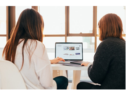 People looking at a computer